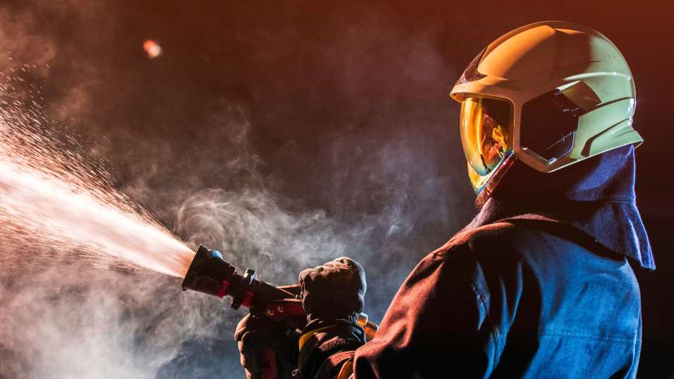 Brandmand i gang med at slukke en brand.